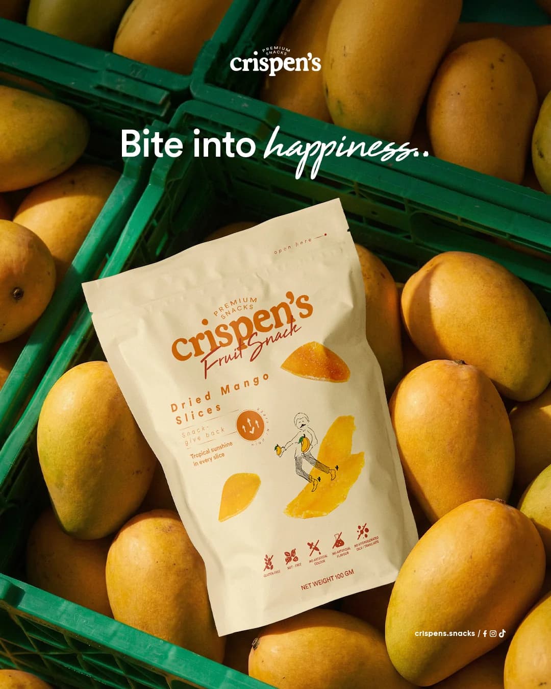 Crispen’s dried mango snack bag surrounded by fresh mangoes